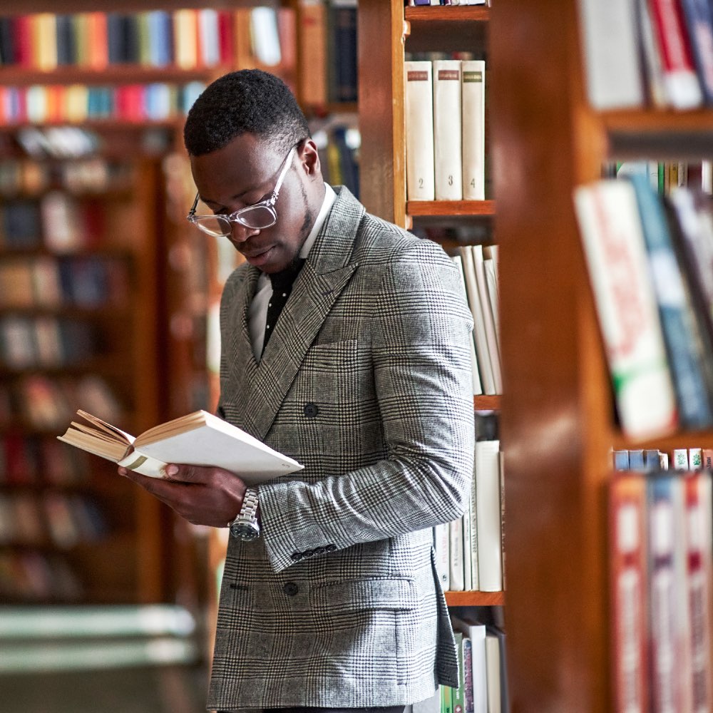 Man reading a book in a library